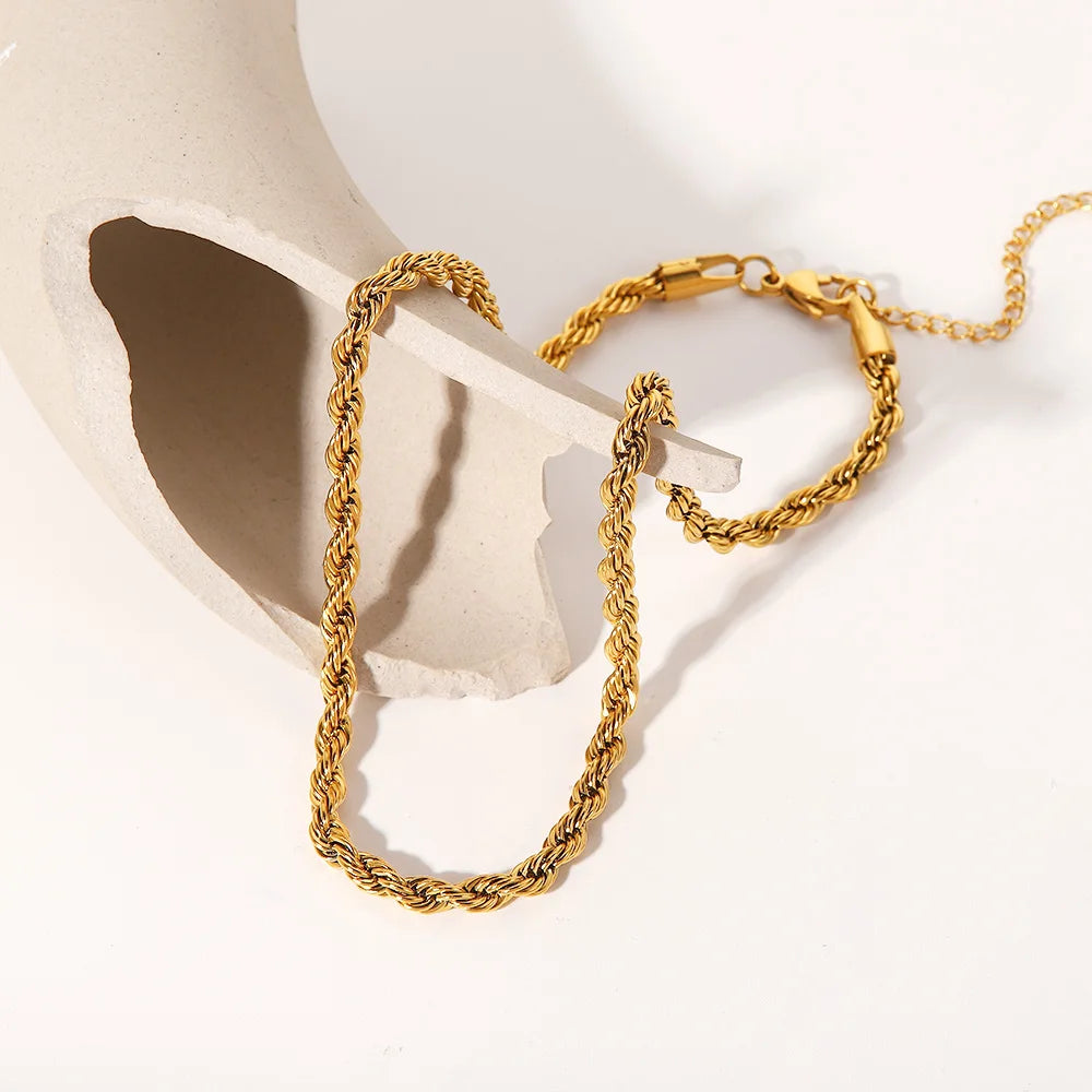 Bold gold statement necklace with twisted chain design and lobster clasp closure