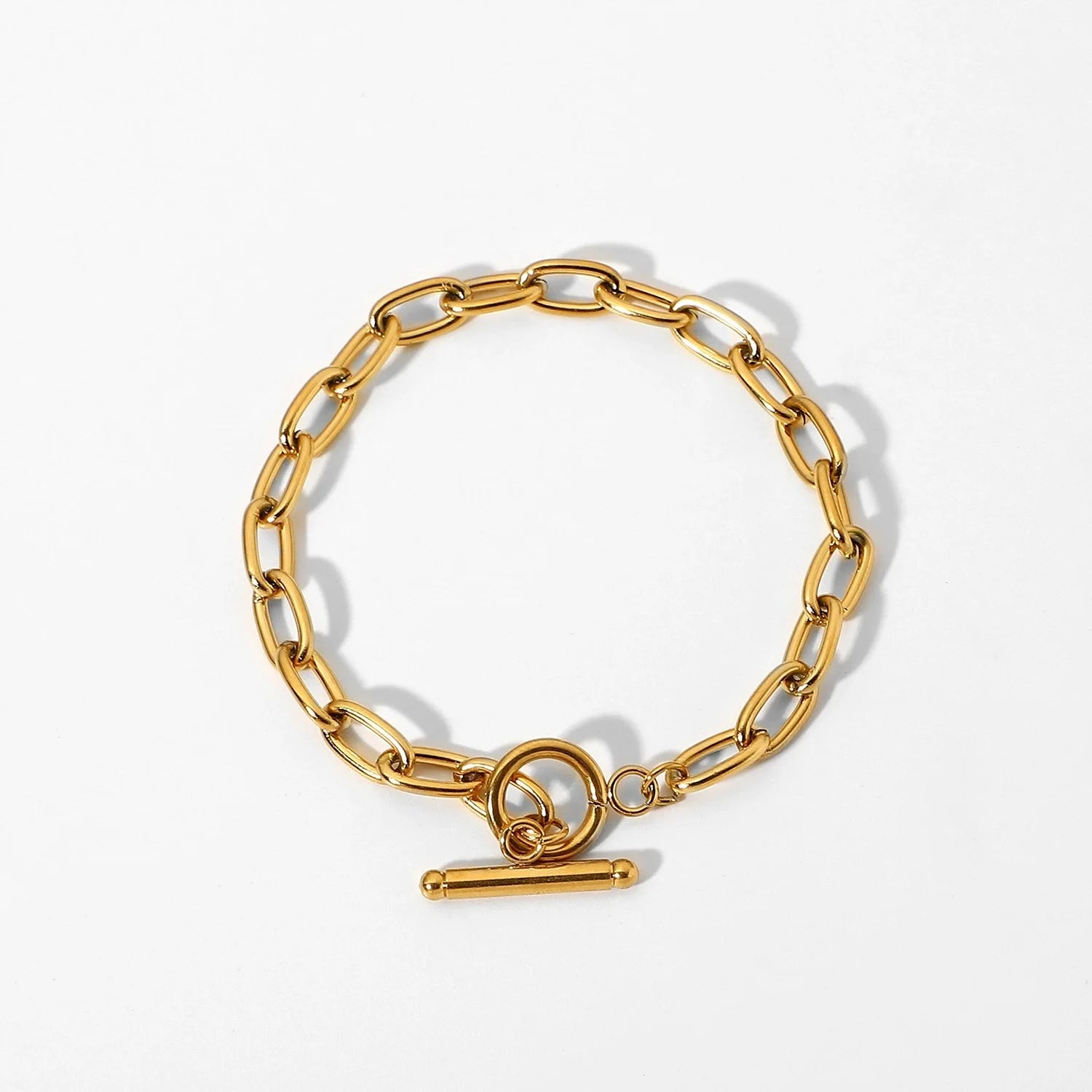 Gold stacked chain bracelet with toggle clasp on white background from A minha loja
